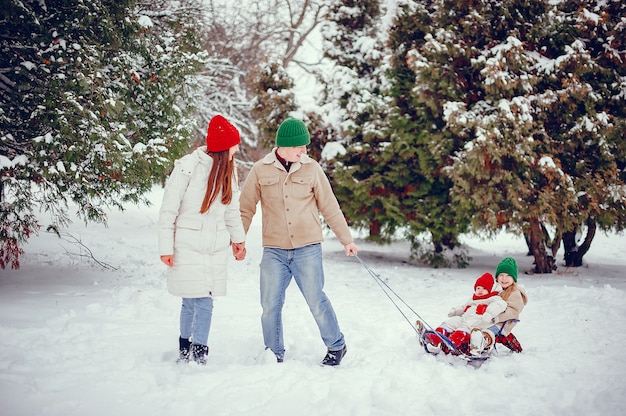 Family with cute daughters in a winter park