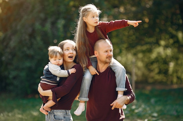 Free Photo family with cute kids in a autumn park