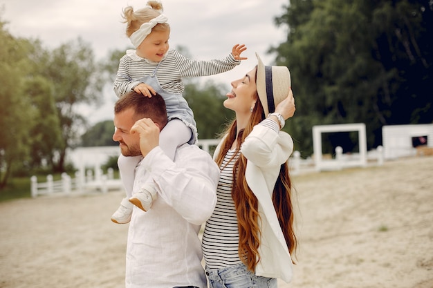 Free photo family with daughter playing in a park