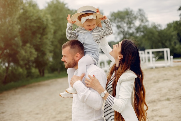 Free photo family with daughter playing in a park