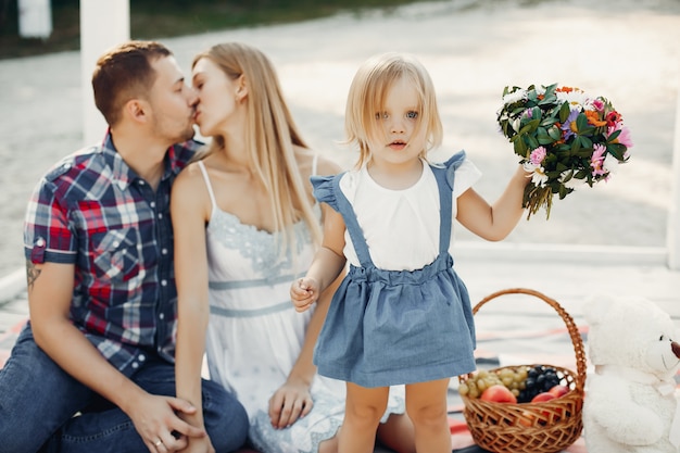 Free photo family with daughter playing on a sand