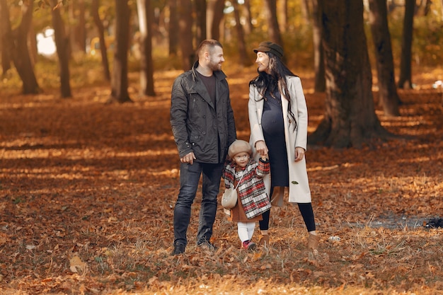 Family with little daughter in a autumn park