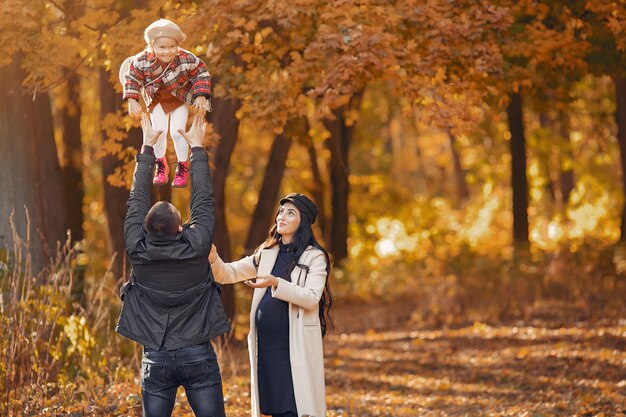 Family with little daughter in a autumn park