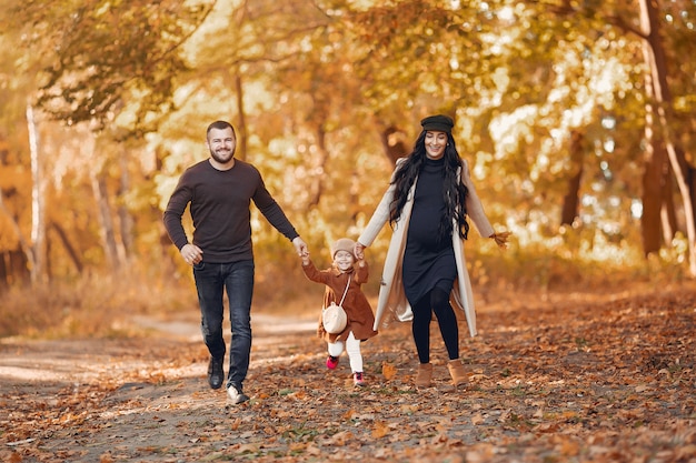 Family with little daughter in a autumn park