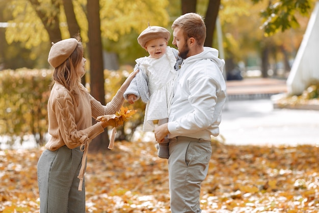 Family with little daughter in a autumn park