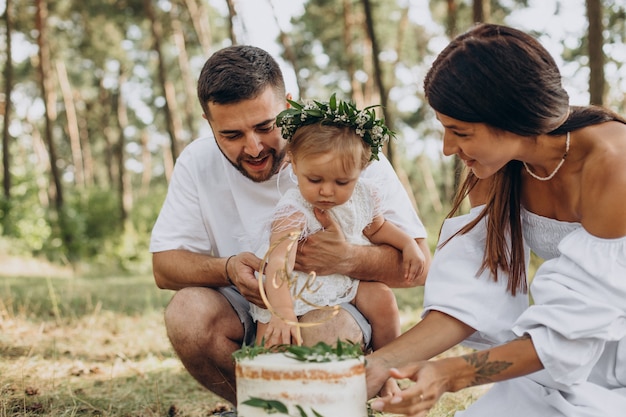 Family with little daughter celebrating first birtday