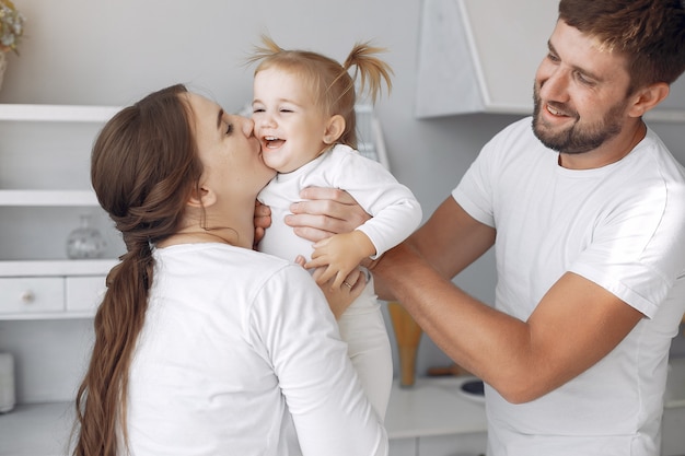 Family with little daughter having fun at home