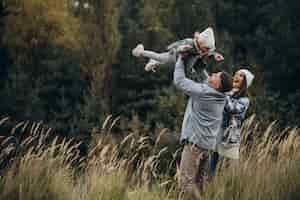 Free photo family with little daughter together in autumnal weather having fun