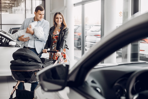 Family with little son in a car salon