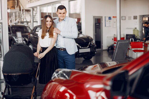 Family with little son in a car salon