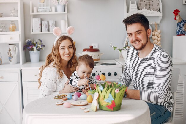 Family with little son painting