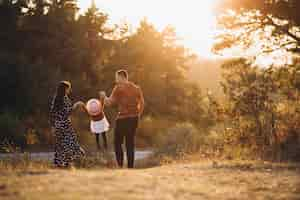 Free photo family with their little daughter in an autumn field