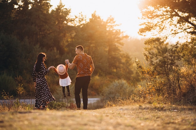 Family with their little daughter in an autumn field