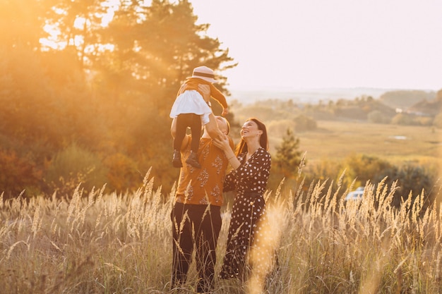 Free photo family with their little daughter in an autumn field