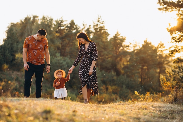 Family with their little daughter in an autumn field