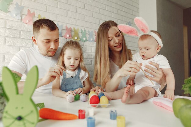 Free Photo family with two kids in a kitchen preparing to easter