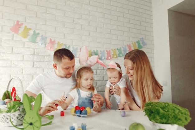 Family with two kids in a kitchen preparing to easter