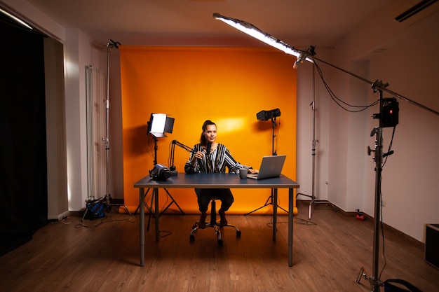 Famous creative woman recording podcast in home studio