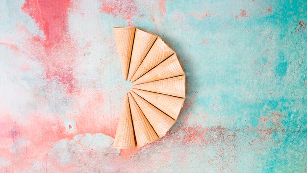 Fan-shaped empty waffle horns on colorful background