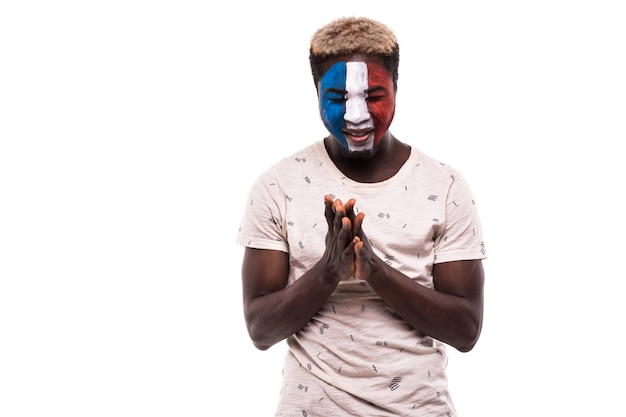 Free photo fan support of afro france national team pray with painted face isolated on white background