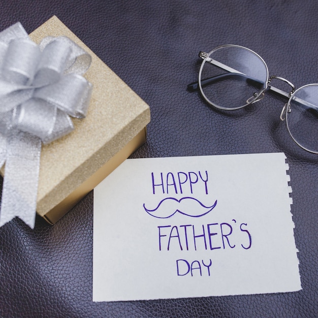 Fantastic father's day composition with gift and glasses