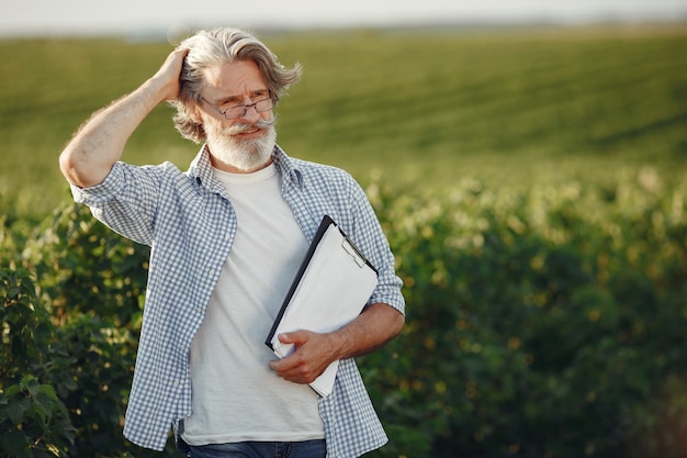 Farmer examines the field. Agronomist or farmer examines the growth of wheat.