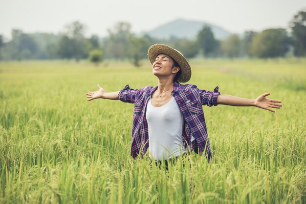 The farmer is in the rice field and takes care of her rice.