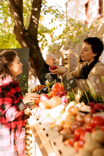 Free photo farmer shows organic apples to client