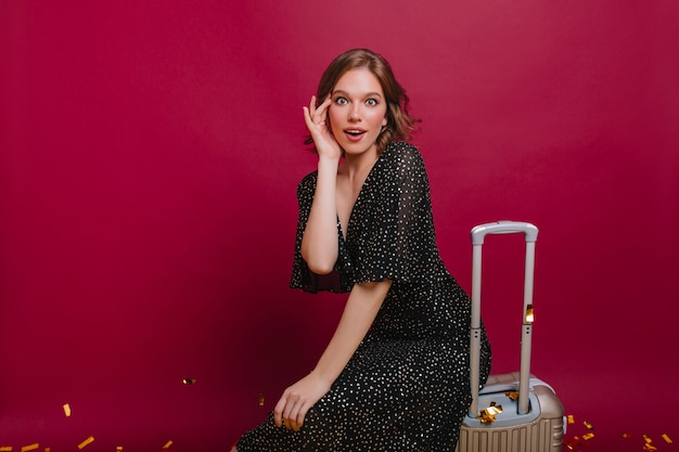 Free photo fascinating girl with short shiny hair can't believe in upcoming travel