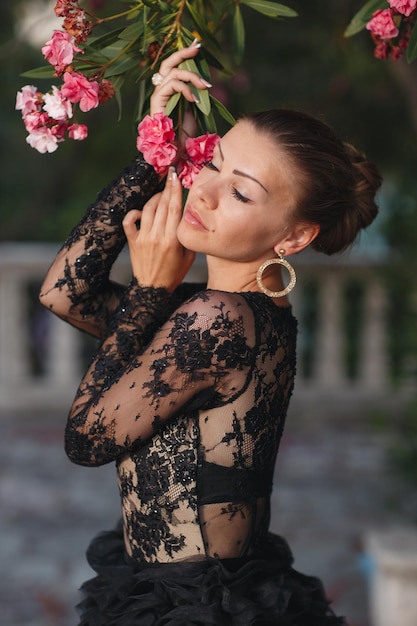 fashion beautiful woman in black luxury dress outdoor