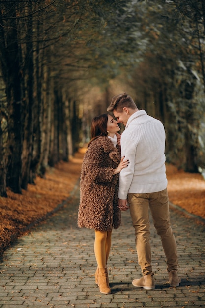 Fashion couple together walking in the park