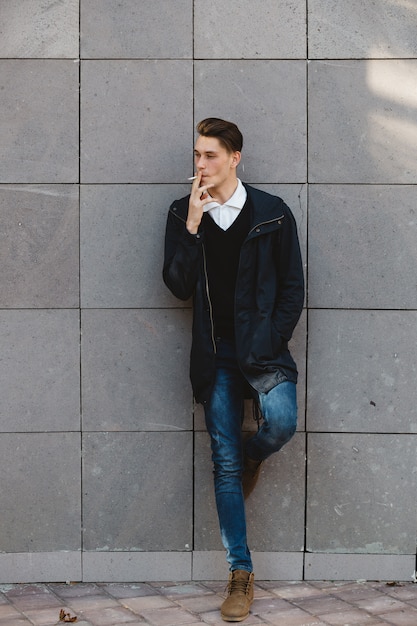 Free photo fashion hipster male model smoking