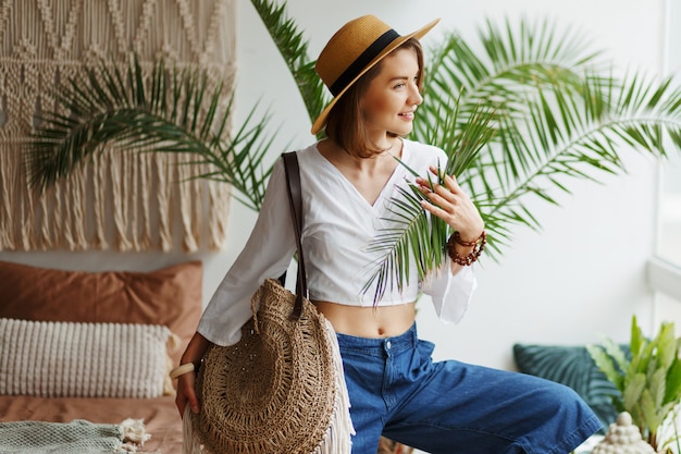 Free photo fashion image of stylish brunette woman posing at home in boho style