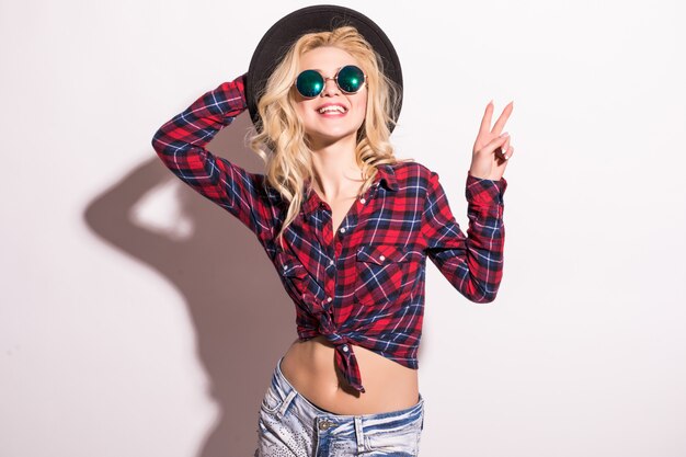 Fashion lady girl in black sunglasses and black hat isolated on pink