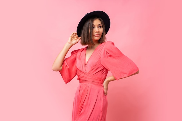 Fashion  photo of lovely brunette woman in  pink dress posing