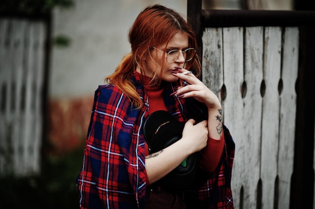 Free Photo fashion portrait of redhaired sexy girl outdoor model attractive seduction woman with cigarette