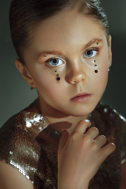 The fashion portrait of young beautiful preteen girl at studio