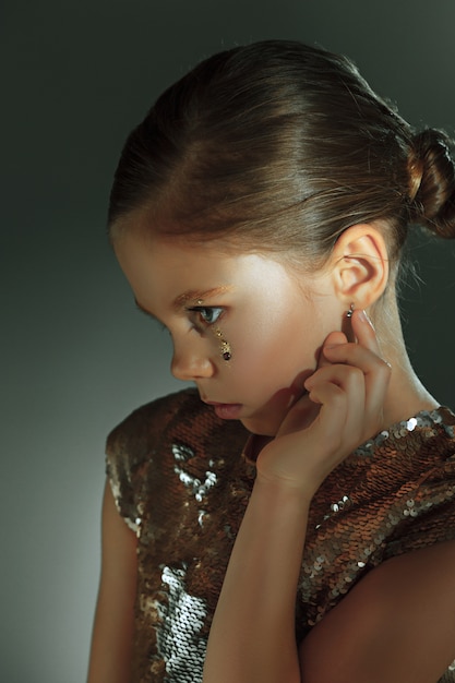 The fashion portrait of young beautiful preteen girl at studio