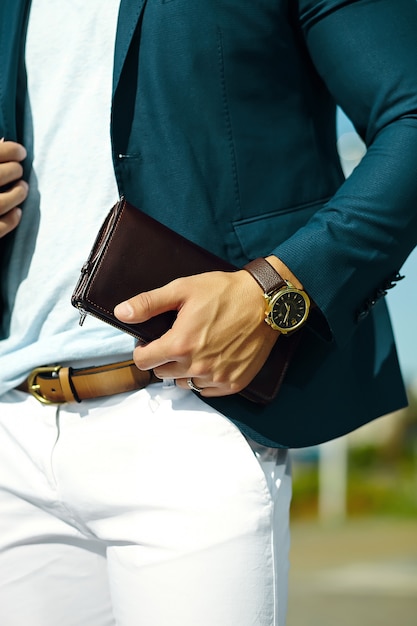 Free Photo fashion portrait of young businessman handsome  model man in casual cloth suit with accesories on hands