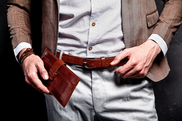 Free Photo fashion portrait of young businessman handsome model man dressed in elegant brown suit with accessories