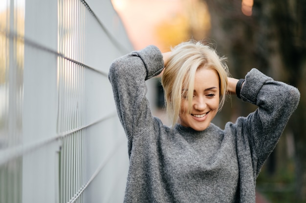 Free Photo fashion street photo session of stylish young lady in a grey clothes