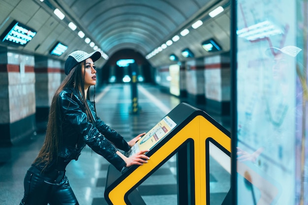 Free photo fashion style model female posing on subway station