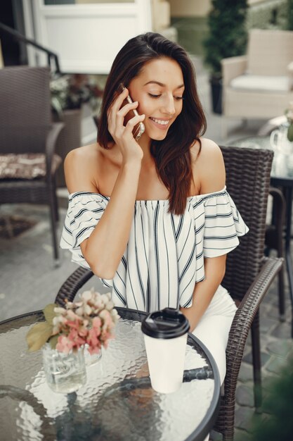 Fashion young girl in a summer cafe