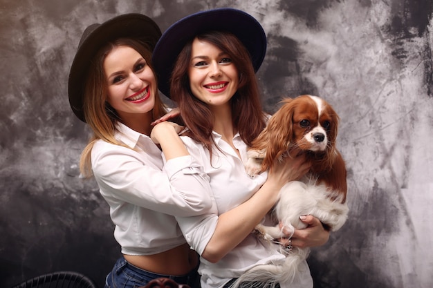 Free photo fashion young women posing with dog