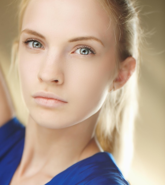 Fashionable bright portrait of blond girl in blue dress.