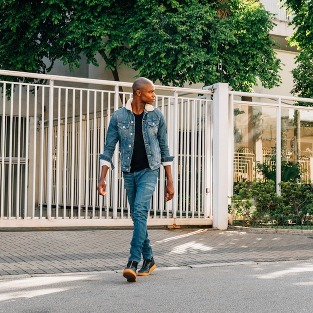 Fashionable handsome african young man crossing the road