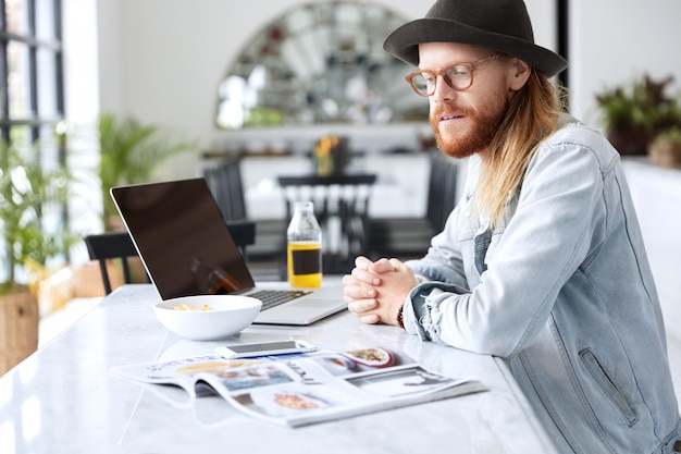 Free Photo fashionable hipster guy dressed in stylish black hat and denim shirt