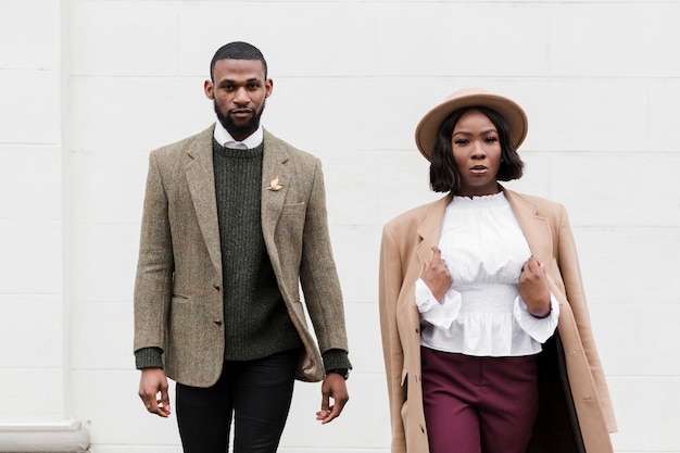 Fashionable man and woman posing