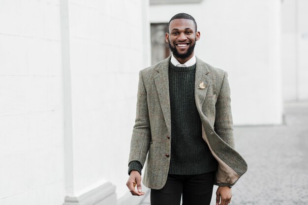 Fashionable smiley man posing outdoors