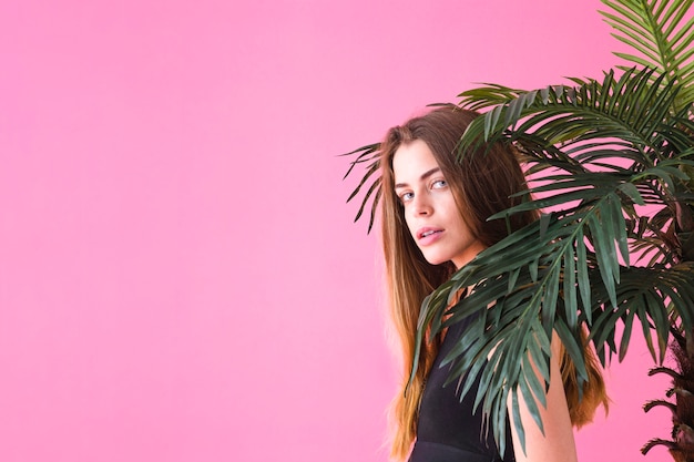 Fashionable woman next to palm tree